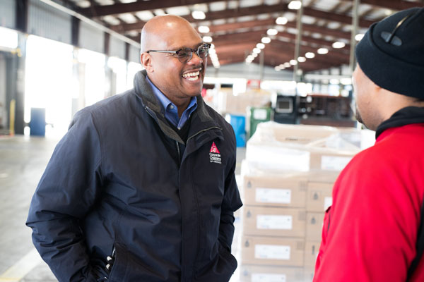 Chaplain speaking to warehouse employee